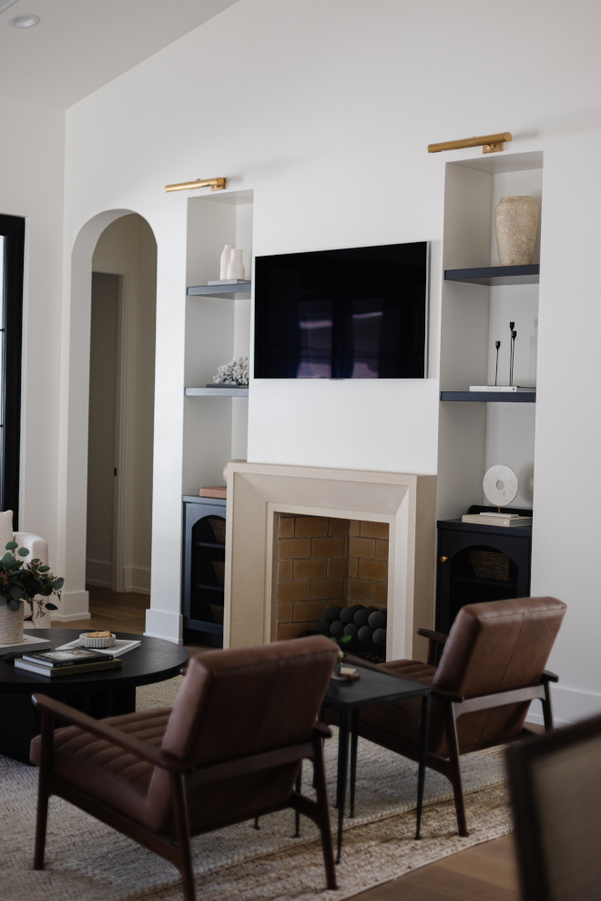 Living room has custom built ins with mesh details and elements of unlacquered brass #Livingroom