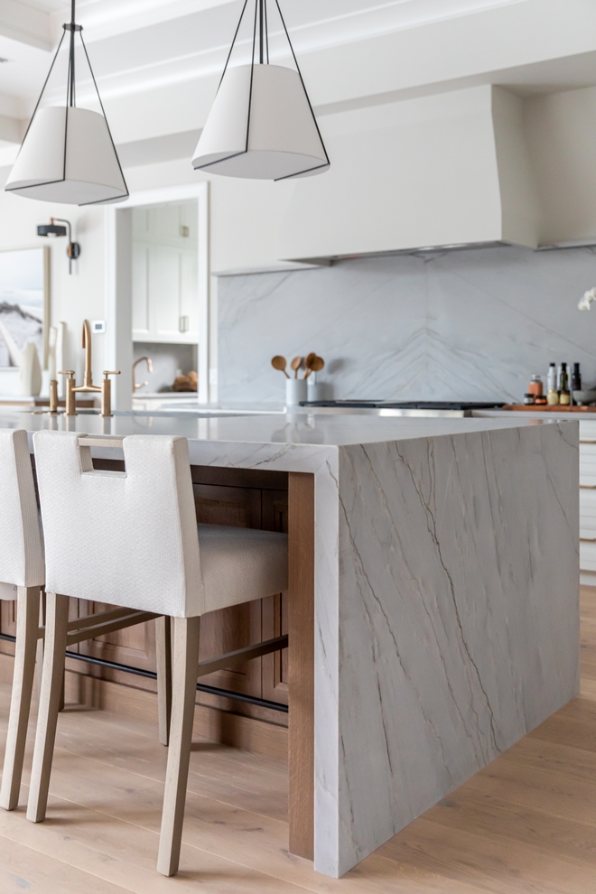 Kitchen features waterfall edge island countertop The waterfall edge is Azzurra Bay Honed Quartzite #Kitchen #waterfalledgeisland #countertop #waterfalledge #AzzurraBay #HonedQuartzite #Quartzite