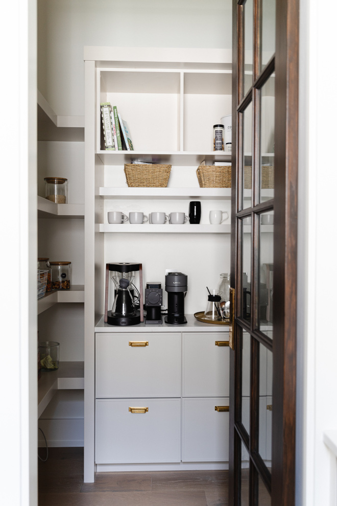 Walk-in pantry features a great combination of cabinet base with open shelving and upper cabinets along with a beverage center with shallow shelving for glassware #walkinpantry #pantry