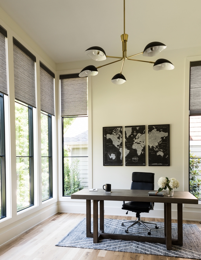 The home office features floor-to-ceiling windows that allow for ample amounts of sunshine to fill the space Trim and walls are Sherwin Williams Greek Villa #homeoffice #windows #paintcolor