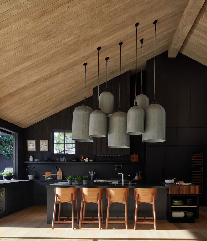 Custom cast concrete pendants by Buzzell Studios provide all the statement needed for this open plan kitchen and living space The ceiling brings the Cedar from outside into the space to connect all the materials #castconcretependants #concretependants #statement #openplan #kitchen #ceiling #Cedar