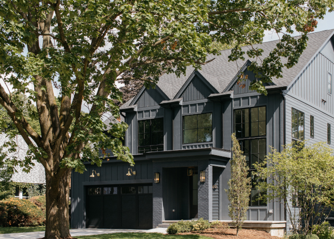 This new-construction Modern Farmhouse features dark siding with black windows and black garage doors This new-construction Modern Farmhouse features dark siding with black windows and black garage doors This new-construction Modern Farmhouse features dark siding with black windows and black garage doors #newconstruction #ModernFarmhouse #darksiding #blackwindows #blackgaragedoor