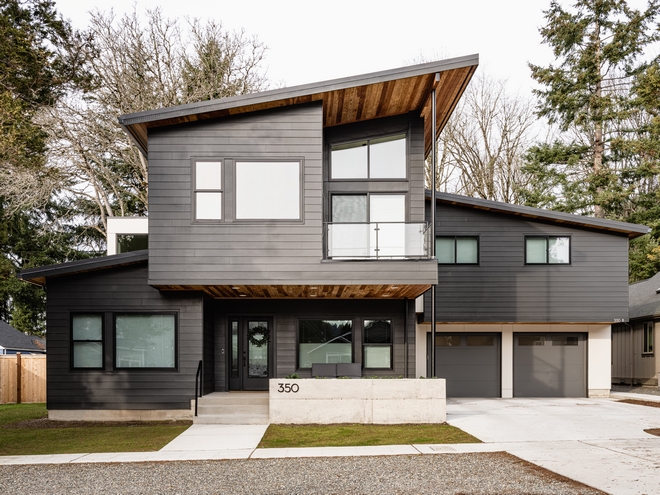 This home boasts plenty of curb-appeal and architectural inspiration Beautiful combination of the dark siding with the Cedar accents #home #curbappeal #architecturalinspiration #Beautifulhome #darksiding #Cedar