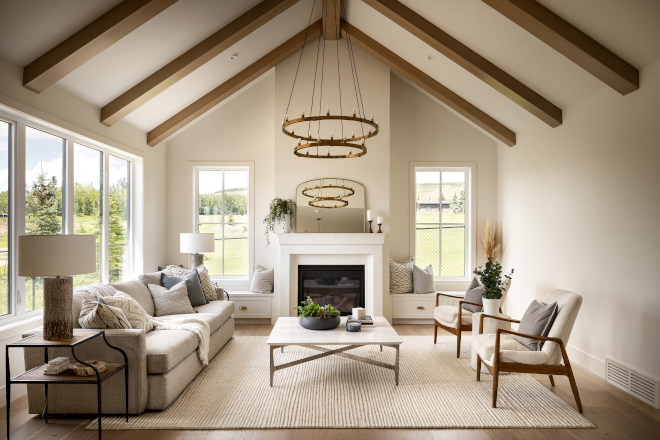 Outside all you see are peaceful country views while inside you are surprised by a two storey vaulted ceiling with beams custom-stained to match flooring #country #twostorey #vaultedceiling #beams #flooring