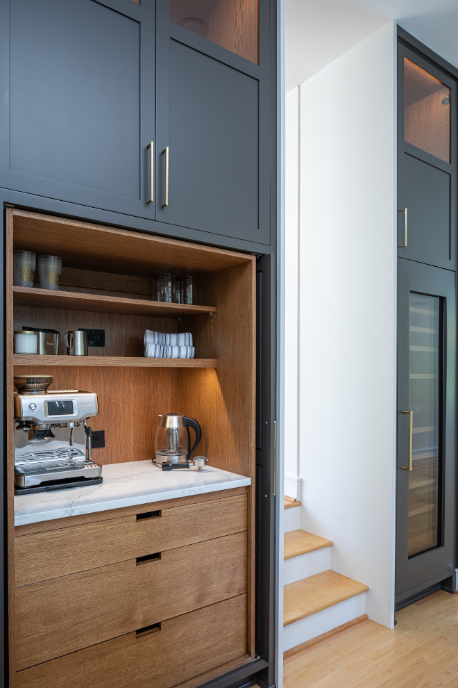 This custom Coffee Station features respectable cabinet doors open shelves with convenient electrical outlets Quartz countertop and lower drawers offering plenty of storage #coffeestation #cabinet #kitchen #appliancegarage 