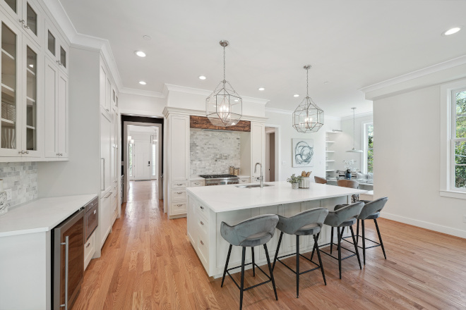 White Kitchen Timeless elements such as marble subway tiles and reclaimed beam add charm to this classic white kitchen #WhiteKitchen #Kitchen #marblesubwaytiles #reclaimedbeam #classicwhitekitchen