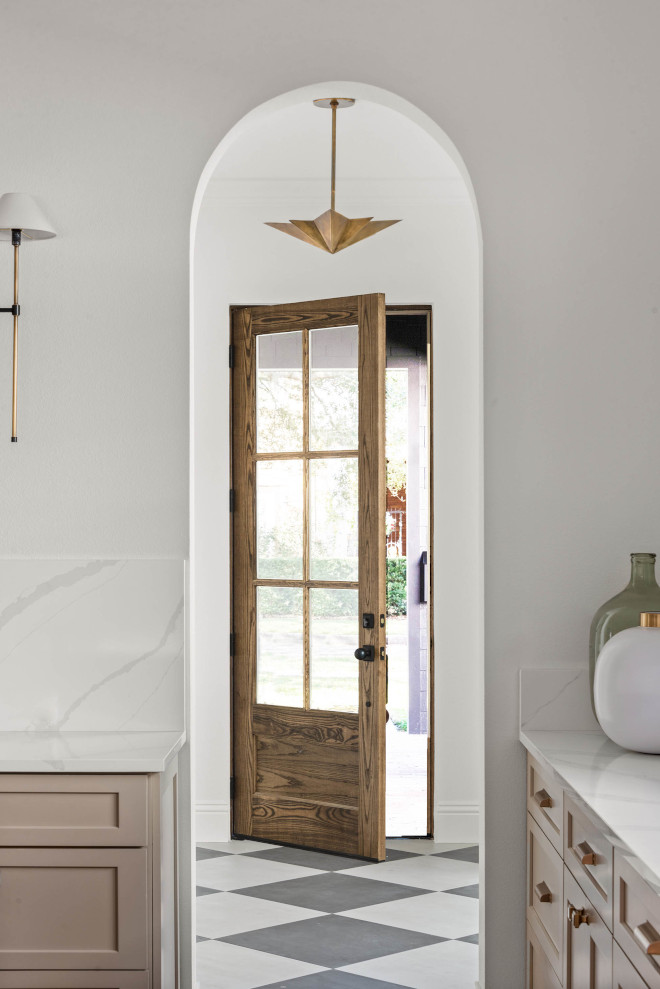 Foyer with matte porcelain tiles in a diamond patterned and a solid wood and glass front door stained in Minwax Dark Walnut #Foyer #matteporcelaintile #diamondpatternedtile #woodandglassdoor #frontdoor #MinwaxDarkWalnut