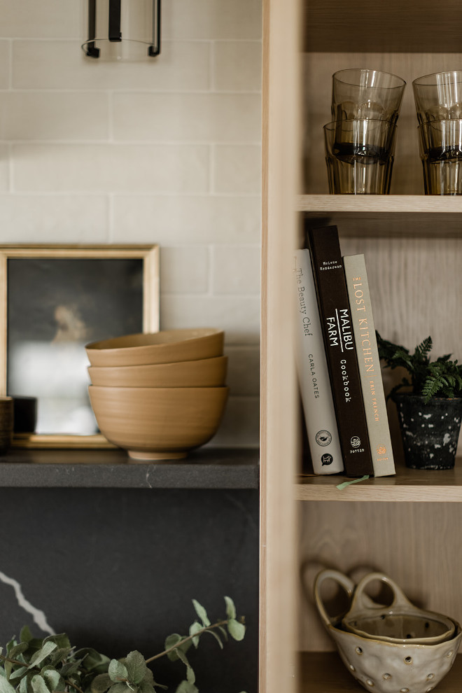 I love the combination of the light wood cabinetry with the soapstone-look backsplash and shelf