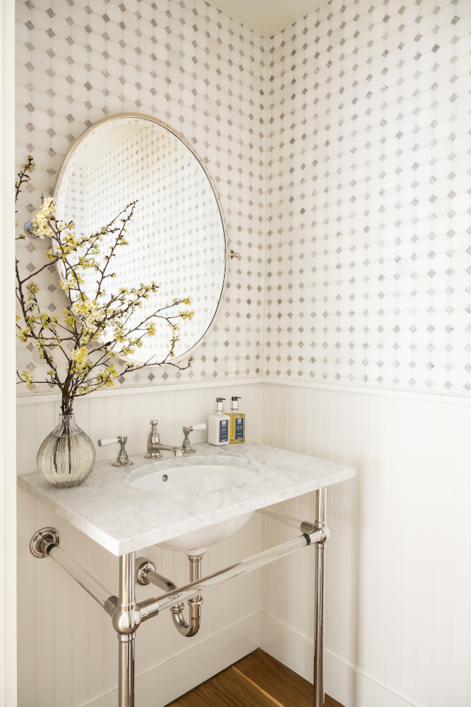 This classic and classy Powder Room features marble mosaic tile walls with painted beadboard chair rail #classicinteriors #classyinteriors #PowderRoom #marblemosaictile #tiledwalls #beadboard #chairrail