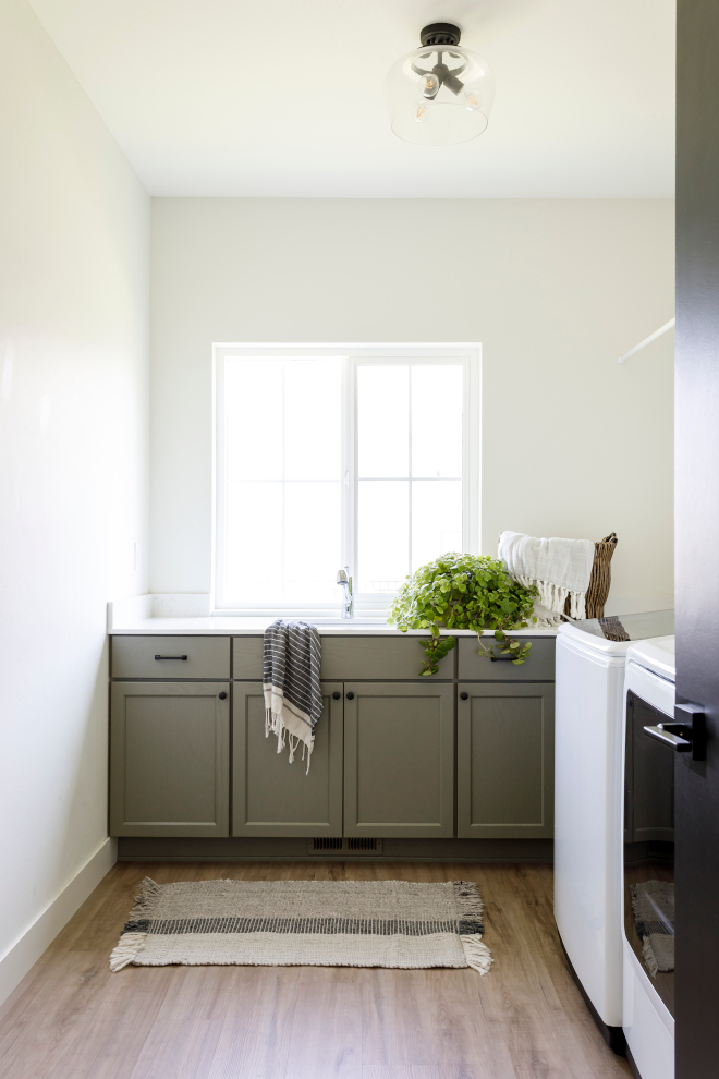 Laundry room The green cabinetry is the star of the show and the natural light from the counter-height window makes doing laundry almost enjoyable #laundryroom #laundryroomideas #greencabinet