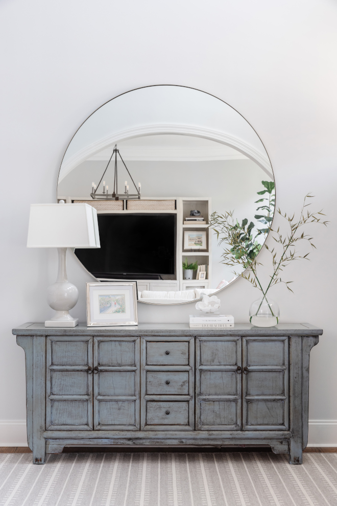 The foyer features a distressed-blue sideboard and an extra large round mirror The foyer features a distressed-blue sideboard and an extra large round mirror #foyer #distressedsideboard #sideboard #extralargemirror #roundmirror