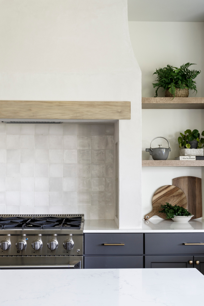 The light plastered hood with zellige-like tile is a statement maker flanked by beautiful dark grey cabinetry and warm oak open shelves The light plastered hood with zellige-like tile is a statement maker flanked by beautiful dark grey cabinetry and warm oak open shelves #plasteredhood #zelligetile #darkgreycabinet #oakopenshelves