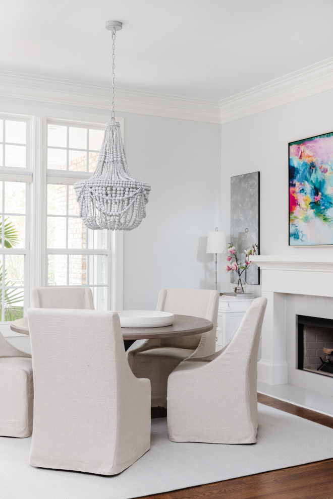 With coastal influences the dining room feels elegant while a fireplace brings a cozy feel to this space #coastal #diningroom