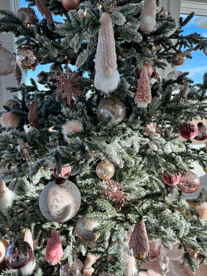 A mix of blush pink gold and silver ornaments add a feminine touch to this Christmas tree