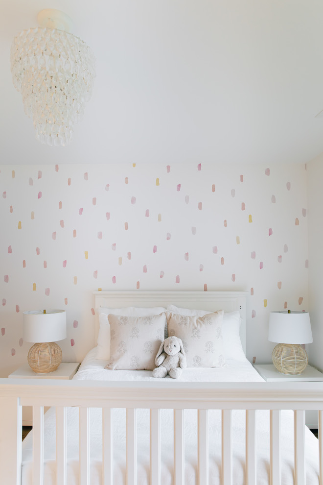 A wall decal with pastel colors along with a teardrop chandelier add a whimsical touch to this girls bedroom So sweet #walldecal #pastelcolors #teardropchandelier #whimsical #girlsbedroom #sweet
