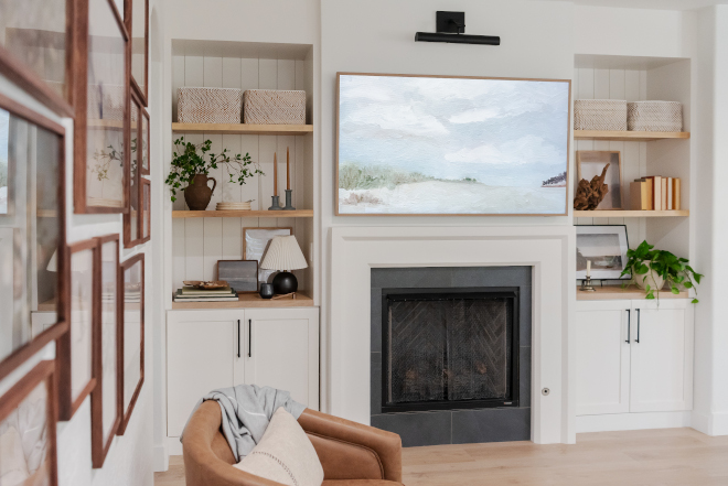 A traditional picture light above the family’s new frame TV above the fireplace gives the room a sophisticated yet relaxed feeling