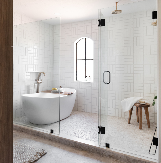 The shower and tub sit in a wet room behind a frameless glass wall and door #wetroom