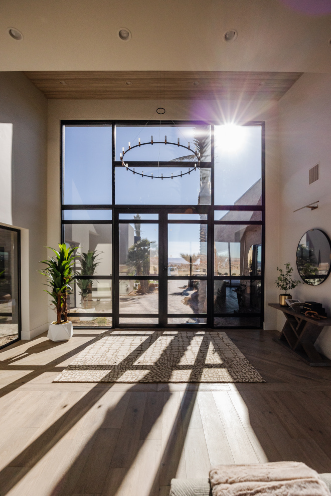 Custom modern metal and glass front door with sidelights complements the tall ceilings and allows abundant sunlight to filter into the foyer Custom modern metal and glass front door with sidelights complements the tall ceilings and allows abundant sunlight to filter into the foyer #Custom #moderndoor #metalandglassdoor #frontdoor #sidelights #tallceilings #sunlight