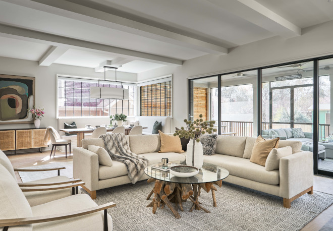 The kitchen and dining area flow into a chic living room that features sliding patio doors #kitchen #diningarea #livingroom #slidingpatiodoors