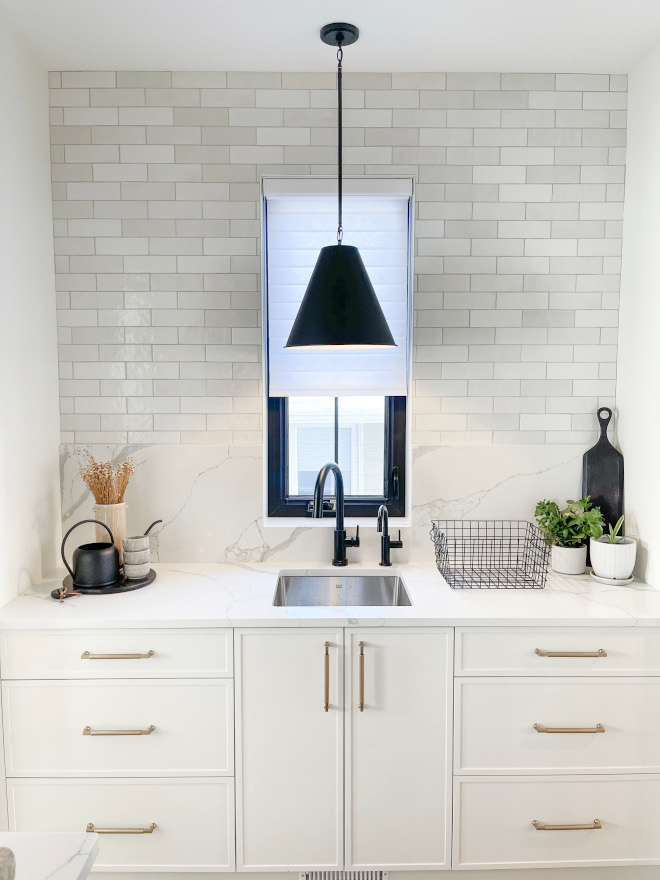 Upon entering the pantry you are greeted by a centrally positioned window pendant light framed against an artisan tiled wall quartz backsplash #pantry