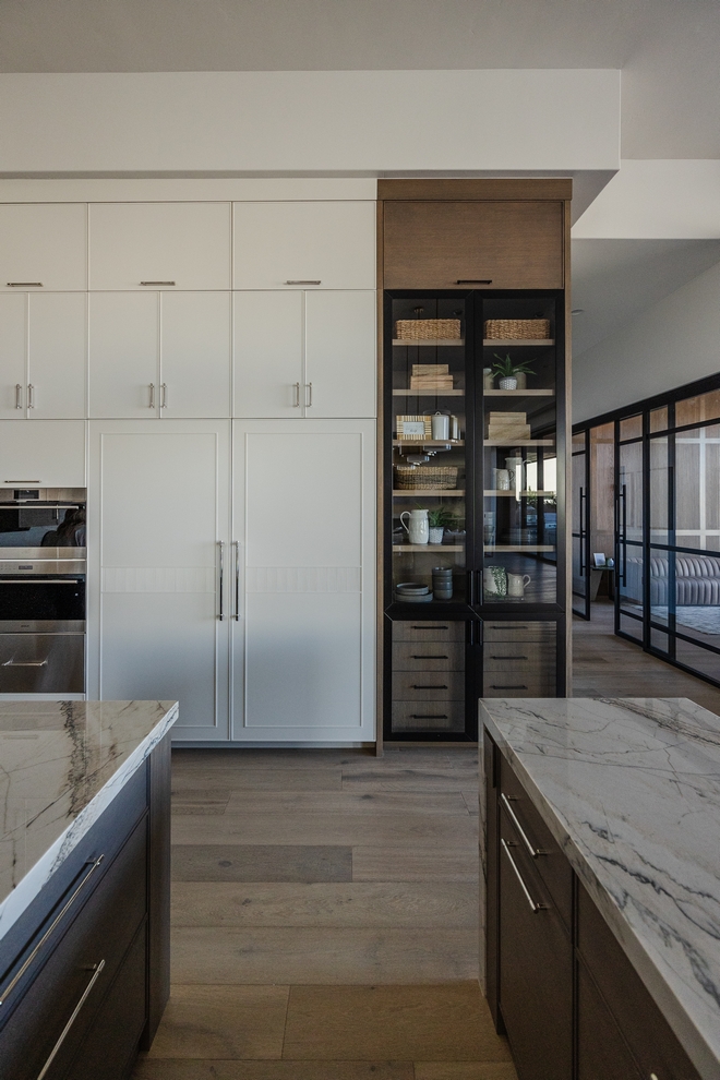 This kitchen also features a gorgeous custom White Oak hutch accentuated with black doors with glass inserts