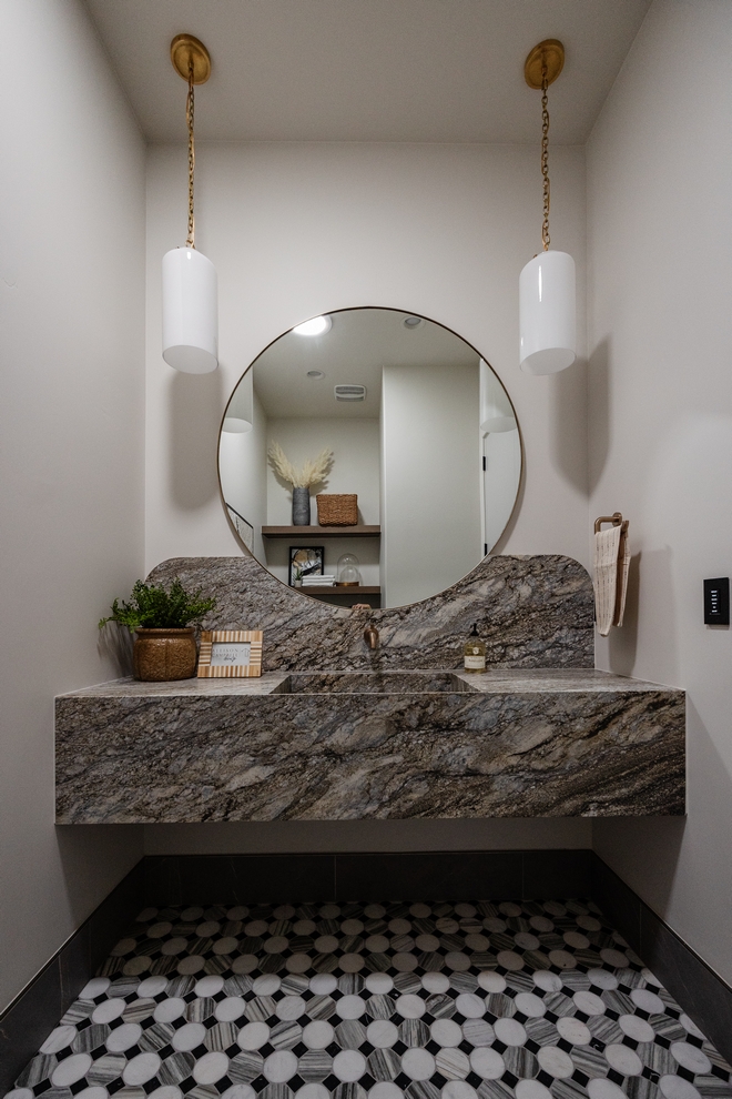 This powder room is captivating and makes you pause to appreciate its beauty I love the mirror integrated seamlessly into the backsplash design Gorgeous