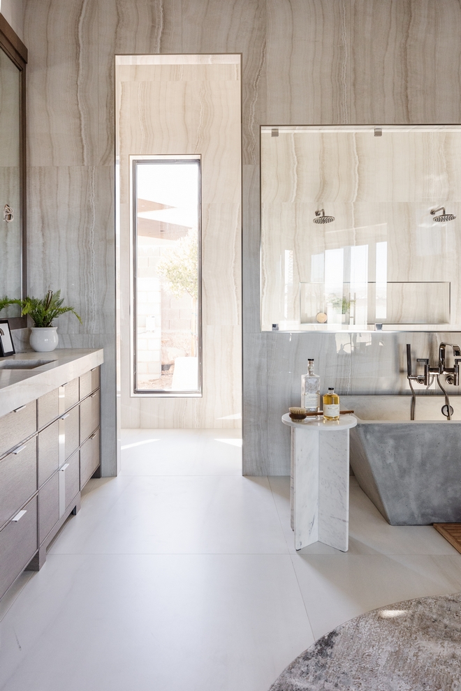 The seamless transition from the floor tile to the shower area enhances the sense of continuity and flow in the bathroom making it truly inviting