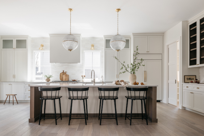 Creamy white kitchen cabinets accentuated by a medium-dark white oak island Creamy white kitchen cabinets accentuated by a medium-dark white oak island #Creamywhitekitchen #kitchencabinets #mediumdark #whiteoak #island