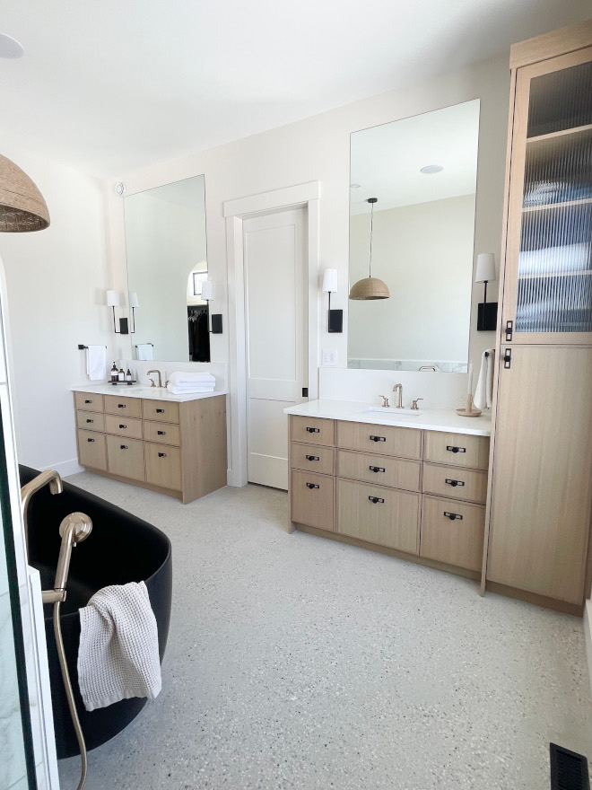 In the bathroom you will find a freestanding matte black bathtub as its focal point framed by artisan tile defining the wall and White oak millwork #bathroom #freestandingtub #matteblackbathtub #Whiteoak #millwork