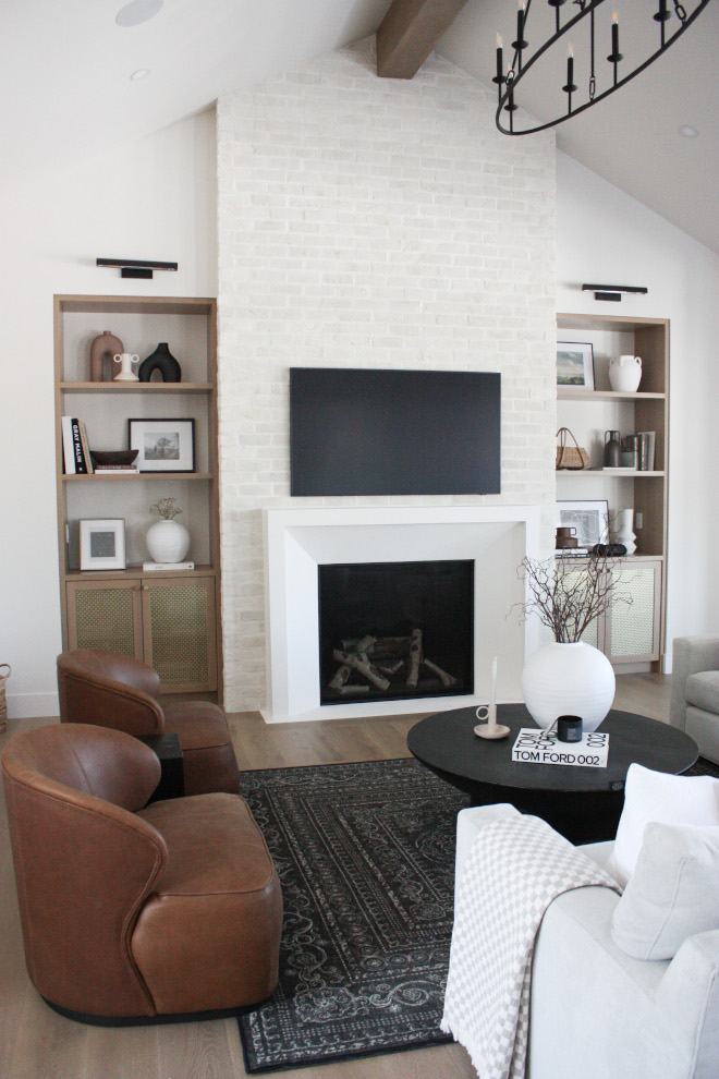 Living room with vaulted ceiling adorned with a striking ceiling beam and overgrouted Brick Fireplace #Livingroom #vaultedceiling #striking #ceilingbeam#overgrouted #Brick #Fireplace
