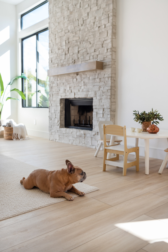 New windows a new stone facade on the fireplace and furnishings that invite comfortable easy living are the main themes of the family room adjacent to the kitchen #familyroom