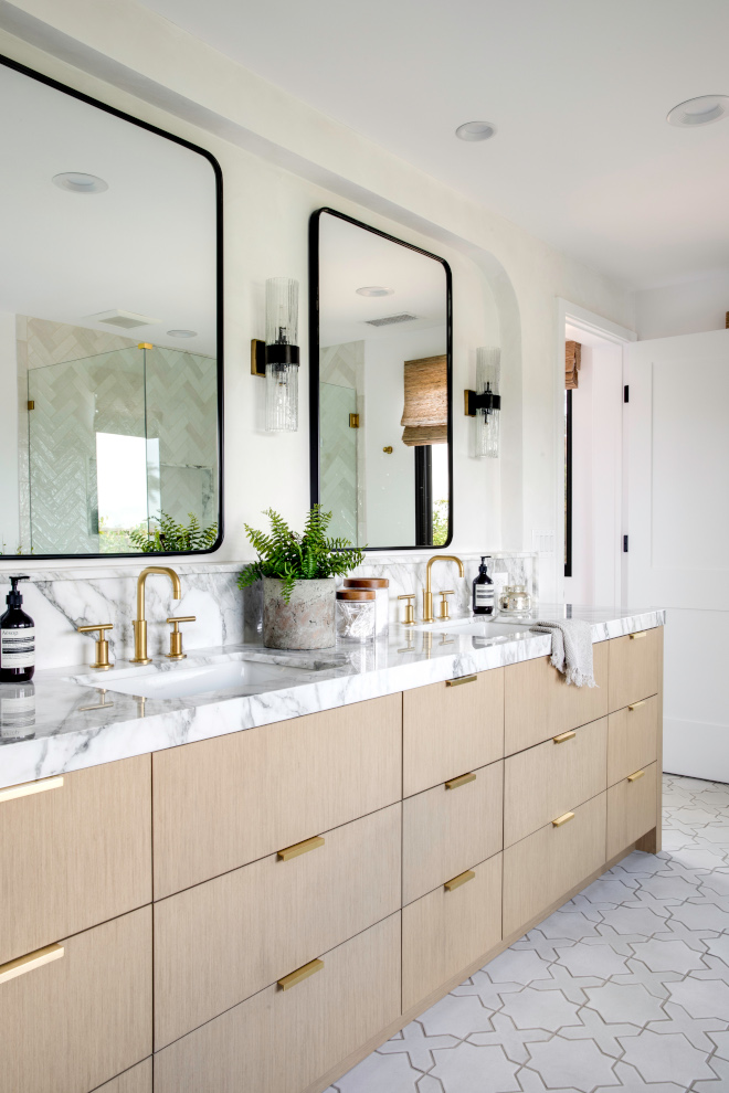 The primary bathroom features a recess on the wall with soft rounded corners around the mirrors providing an elegant design detail and extra top areas #bathroom #recessed