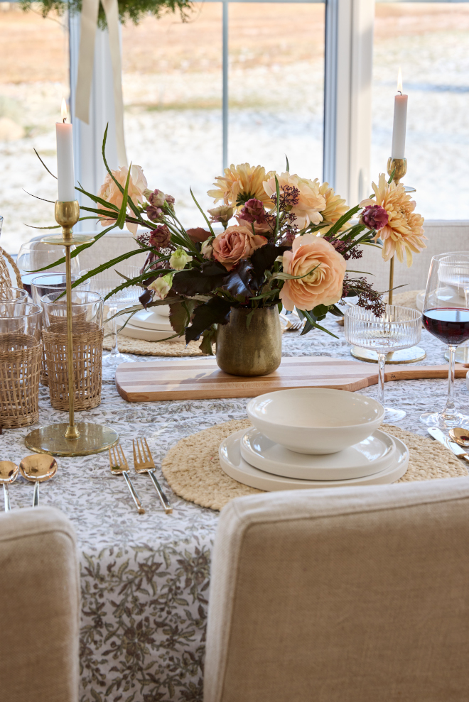 Featuring fresh flowers and beautiful golden candleholders the tabletop feels as feminine as it feels festive #centerpiece #tabletop