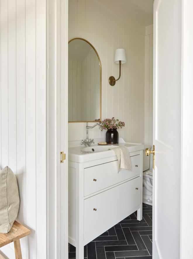 Powder Room This powder room is ideally situated adjacent to the mudroom and laundry area and its design feels cohesive with the surrounding spaces #powderroom #mudroom #slatetile