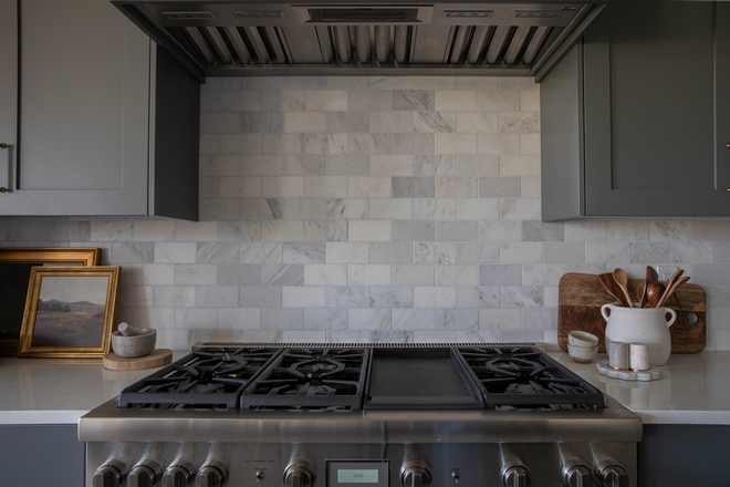 Sherwin Williams Roycroft Pewter Grey kitchen cabinet with honed marble backsplash