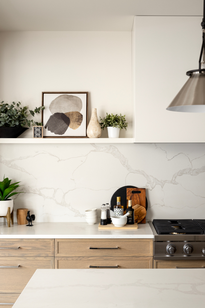 A custom drywall hood paired with a quartz slab backsplash and ledge gives this kitchen a sleek aesthetic #drywallhood #quartz #slabbacksplash #ledge #backplashledge #kitchen #sleek #aesthetic