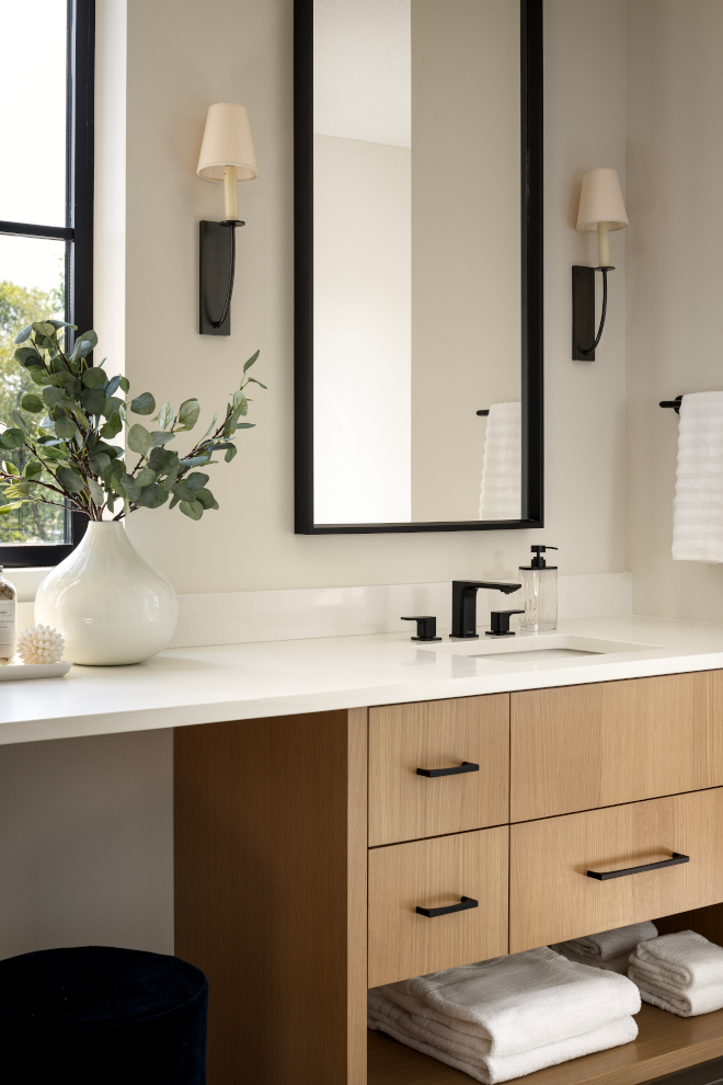 the continuity of the countertop unites the separated bathroom vanities creating a make-up area in between the continuity of the countertop unites the separated bathroom vanities creating a make-up area in between
