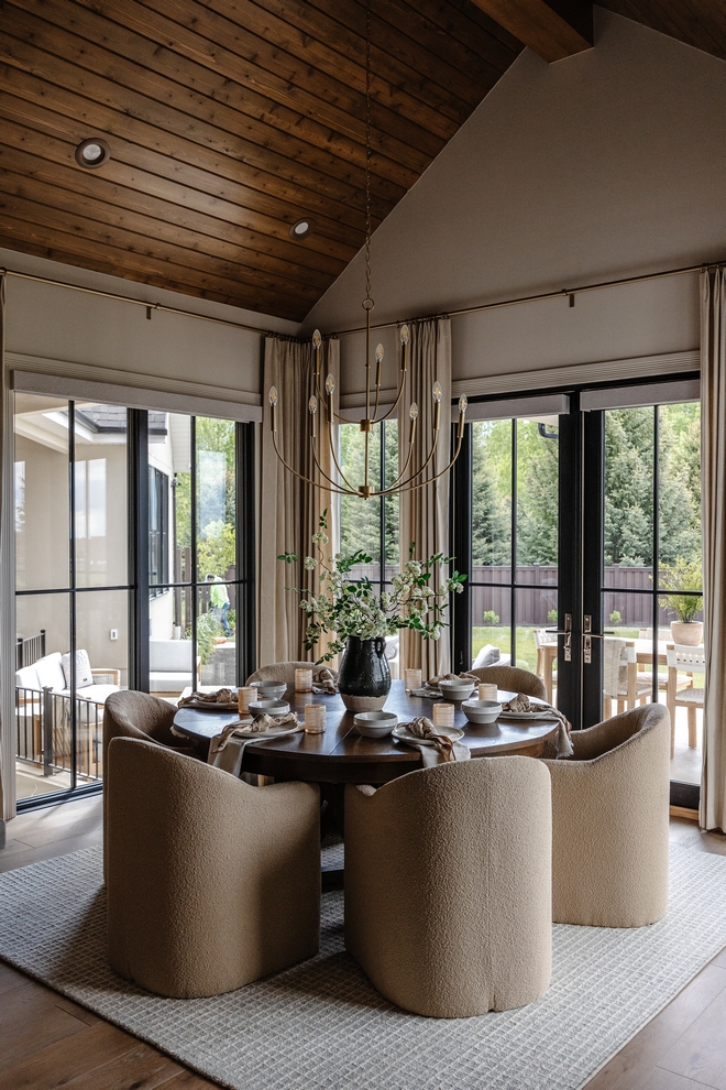 Dining room With its cathedral ceilings and floor-to-ceiling windows leading to the back porch sunlight pours in through the large windows enveloping the entire area in a warm inviting glow #diningroom #floortoceiling #windows #cathedralceiling