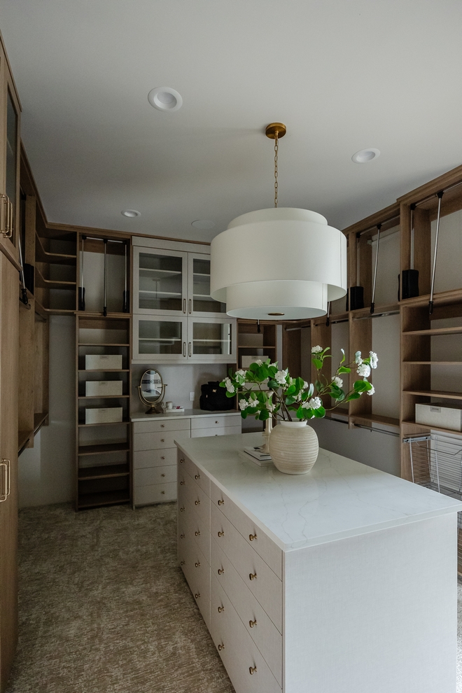 Featuring custom cabinetry and an island that offers plenty of storage the primary closet serves as a luxurious retreat offering both practicality and style in one beautifully appointed area