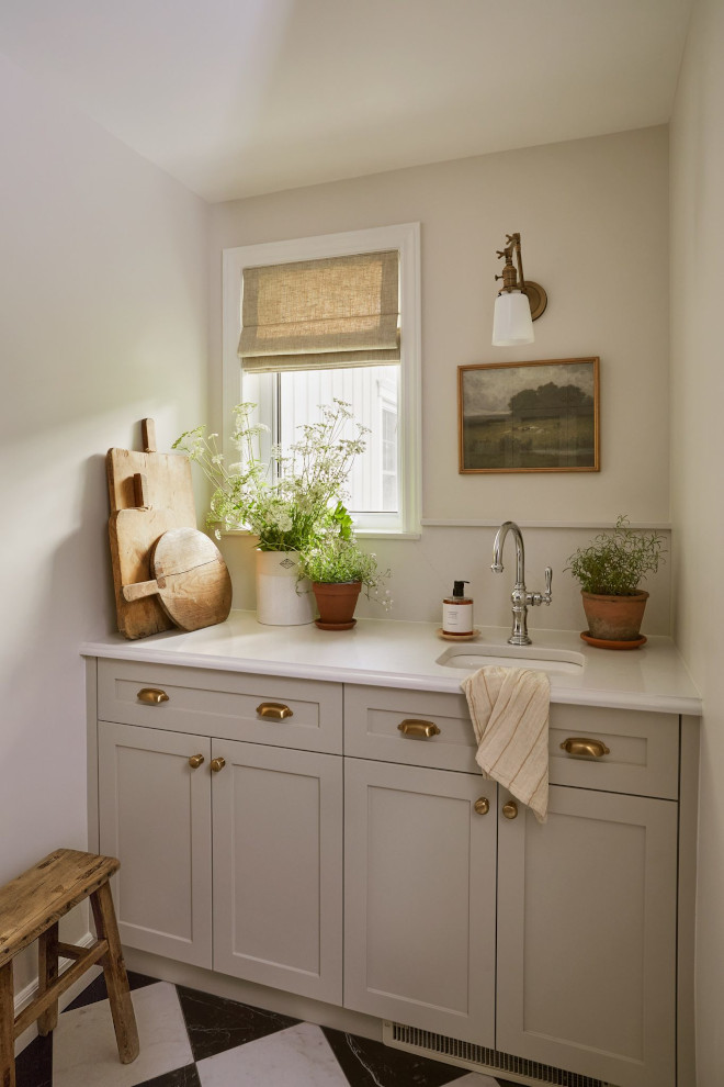 Pantry wall painted in Benjamin Moore Seapearl with built-in sink, narrow ledge, and soft natural light from small window.