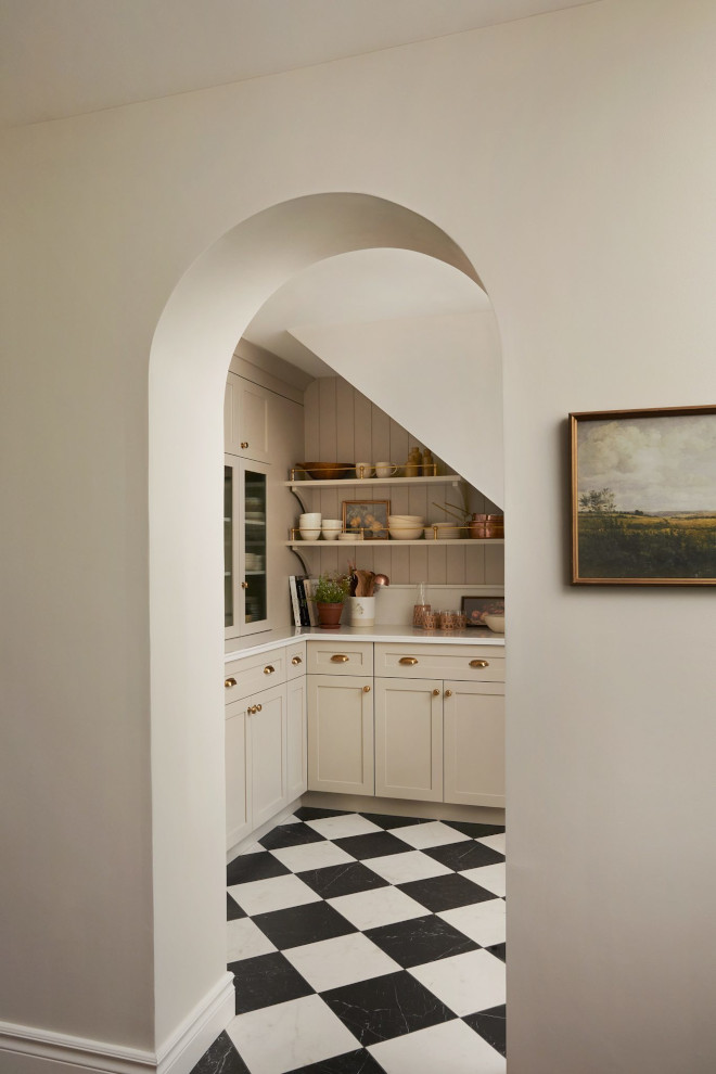 Pantry cabinetry painted in Benjamin Moore Revere Pewter with beadboard backsplash and brass accents in French country kitchen.