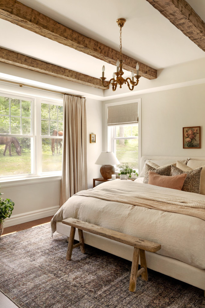 Cozy French country bedroom with layered Belgian linen bedding, soft neutral tones, and linen pinch-pleat curtains.