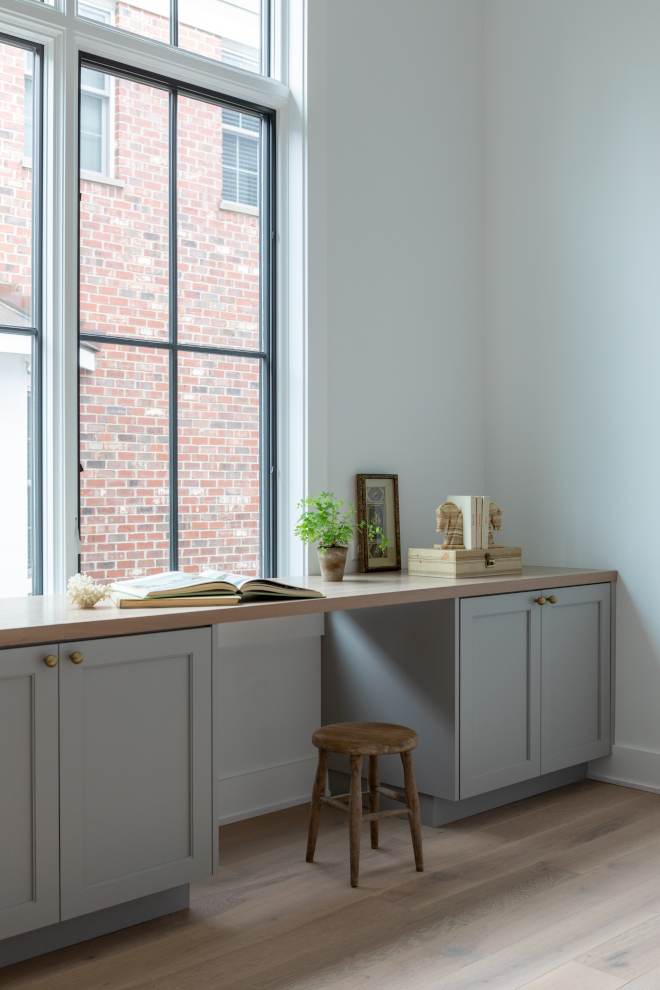 Sherwin Williams Warm Pewter paint color used on custom cabinetry for a cohesive neutral interior.