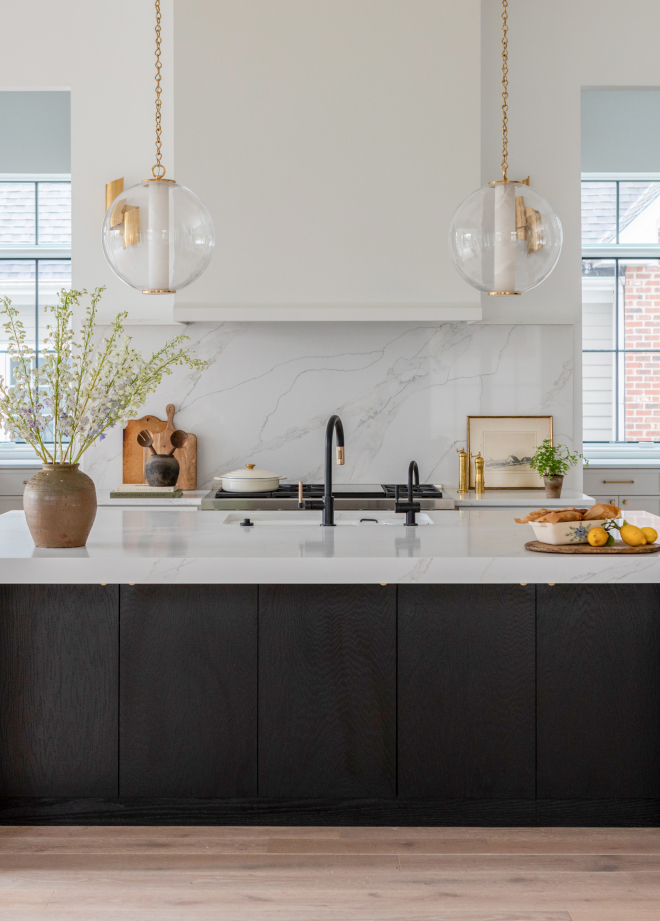 Kitchen island pendant lighting ideas with two elegant pendants placed over a large island in a new construction kitchen.