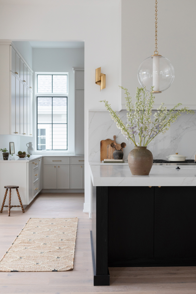 Kitchen view into back pantry with Benjamin Moore Chantilly Lace walls, light engineered hardwood floors, and a neutral runner.