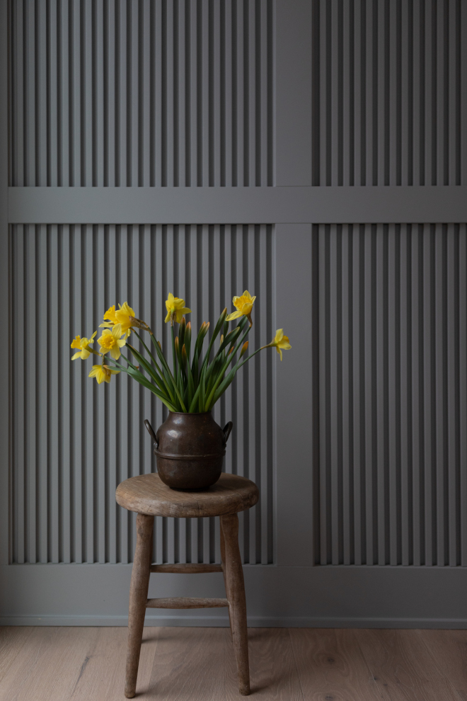 Second-floor landing featuring reeded wall paneling painted Farrow & Ball Lamp Room Gray No.88.