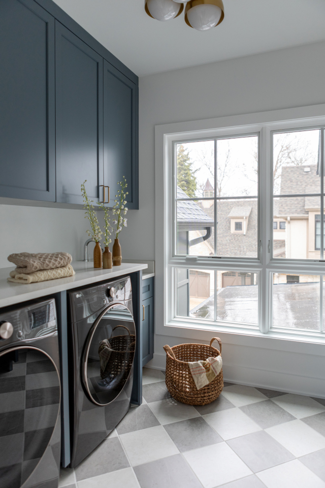 Second-floor laundry room with natural light, marble-look checkered tile floors, and cabinet paint color ideas.