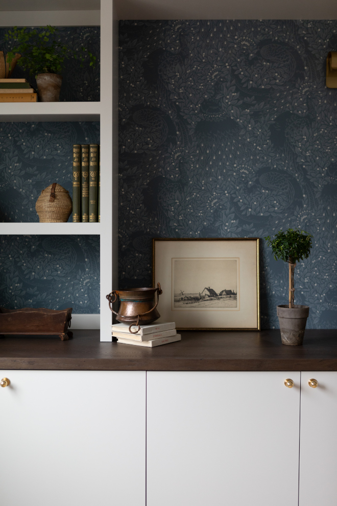 Close-up of Sherwin Williams Taupe of the Morning cabinet paint color paired with wallpaper and white oak shelving.