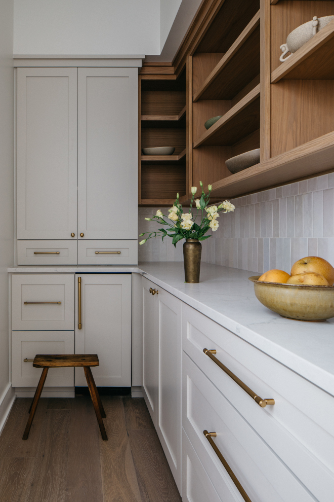 2026-new-home-butlers-pantry-gossamer-veil-white-oak-vertical-tile Butler’s pantry with Sherwin Williams Gossamer Veil lower cabinets, white oak open shelving, and vertical stack offset backsplash tile in a 2026 new construction home.