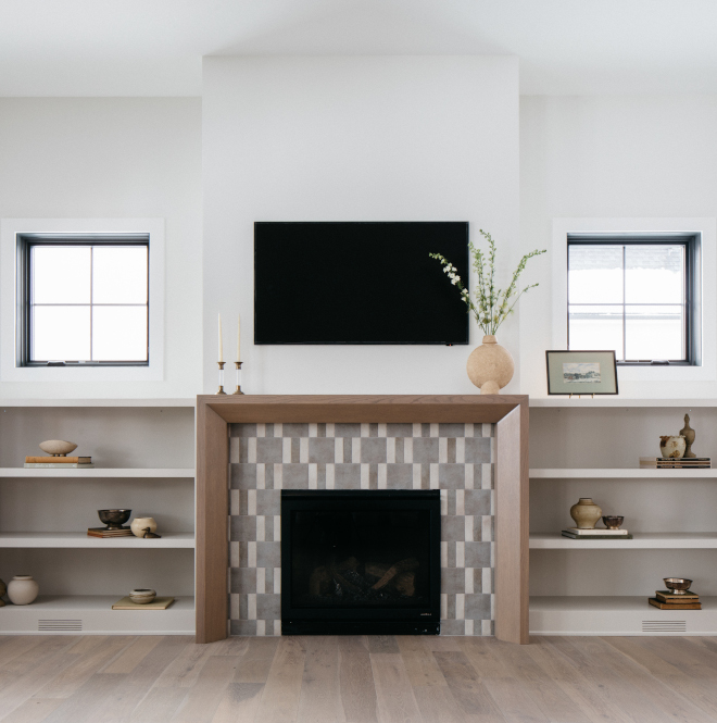 2026-new-home-great-room-white-oak-fireplace-gossamer-veil-builtins Great room with mitered white oak fireplace surround, Gossamer Veil built-ins, and Chantilly Lace trim in a 2026 new construction home.